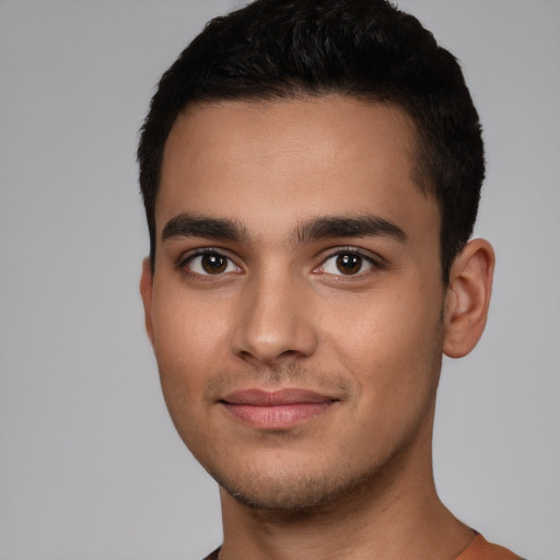 Joyful white young-adult male with short  black hair and brown eyes