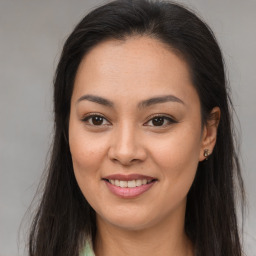 Joyful latino young-adult female with long  brown hair and brown eyes