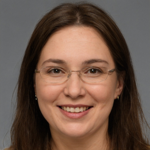 Joyful white adult female with long  brown hair and brown eyes