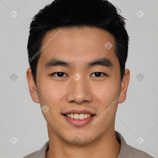 Joyful asian young-adult male with short  black hair and brown eyes