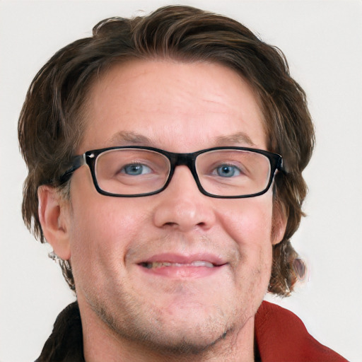 Joyful white adult male with medium  brown hair and blue eyes