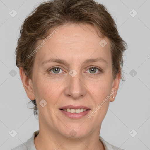 Joyful white adult female with short  brown hair and grey eyes