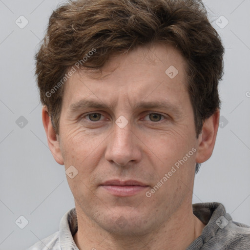 Joyful white adult male with short  brown hair and grey eyes