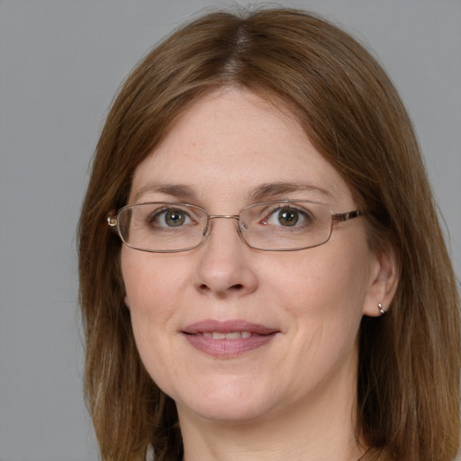 Joyful white adult female with long  brown hair and grey eyes