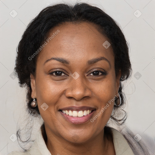 Joyful black adult female with medium  brown hair and brown eyes