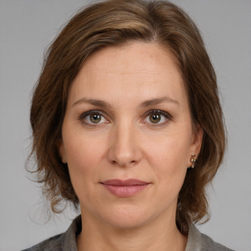 Joyful white adult female with medium  brown hair and brown eyes