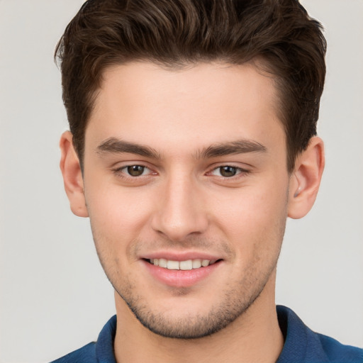 Joyful white young-adult male with short  brown hair and brown eyes