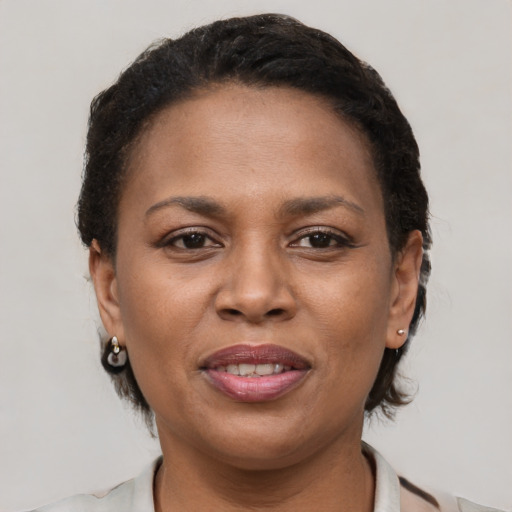 Joyful black young-adult female with short  brown hair and brown eyes