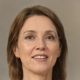 Joyful white adult female with medium  brown hair and grey eyes