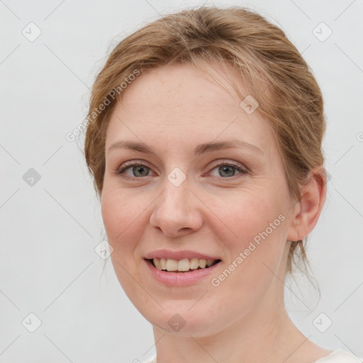 Joyful white young-adult female with medium  brown hair and blue eyes