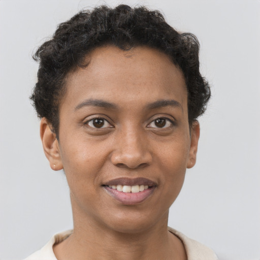 Joyful black young-adult female with short  brown hair and brown eyes