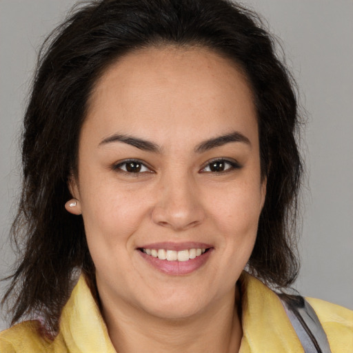 Joyful latino young-adult female with medium  brown hair and brown eyes