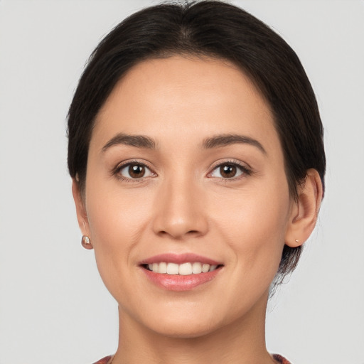 Joyful white young-adult female with short  brown hair and brown eyes