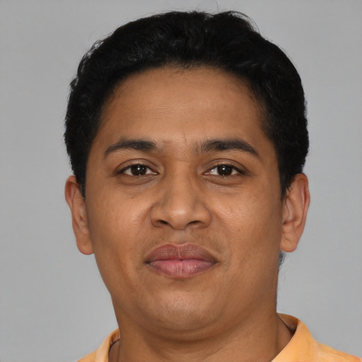 Joyful latino adult male with short  black hair and brown eyes