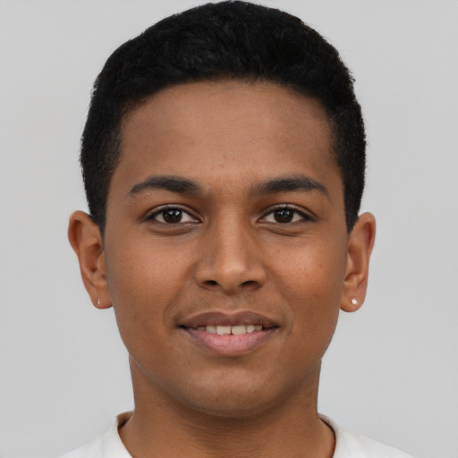 Joyful latino young-adult male with short  brown hair and brown eyes