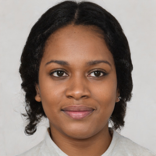 Joyful black young-adult female with medium  black hair and brown eyes