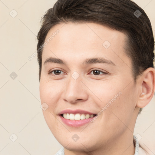 Joyful white young-adult male with short  brown hair and brown eyes