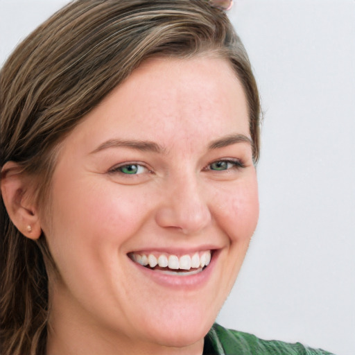 Joyful white young-adult female with long  brown hair and blue eyes