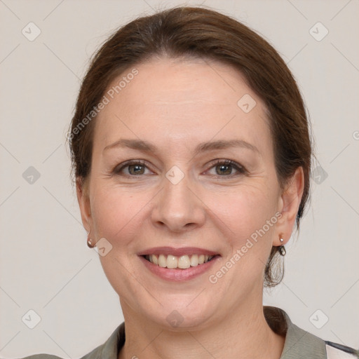 Joyful white adult female with medium  brown hair and grey eyes