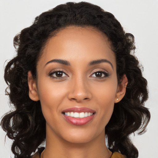 Joyful latino young-adult female with long  brown hair and brown eyes