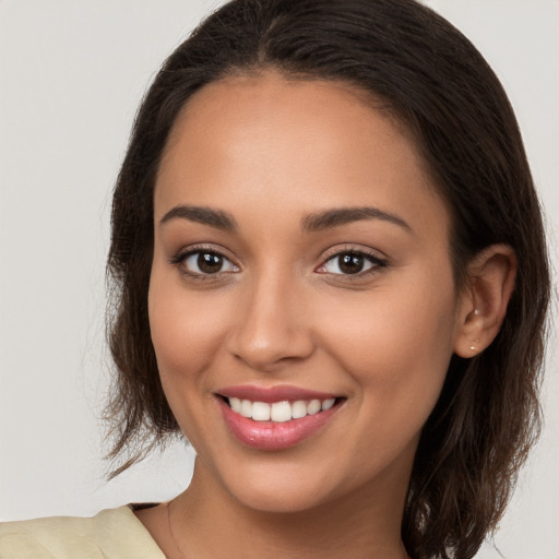 Joyful white young-adult female with long  brown hair and brown eyes