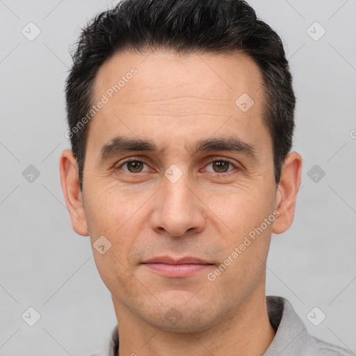 Joyful white adult male with short  brown hair and brown eyes