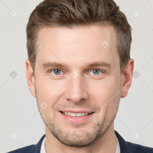 Joyful white young-adult male with short  brown hair and grey eyes