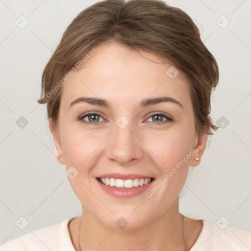 Joyful white young-adult female with short  brown hair and grey eyes