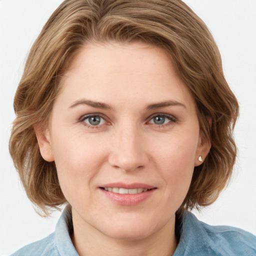 Joyful white young-adult female with medium  brown hair and blue eyes