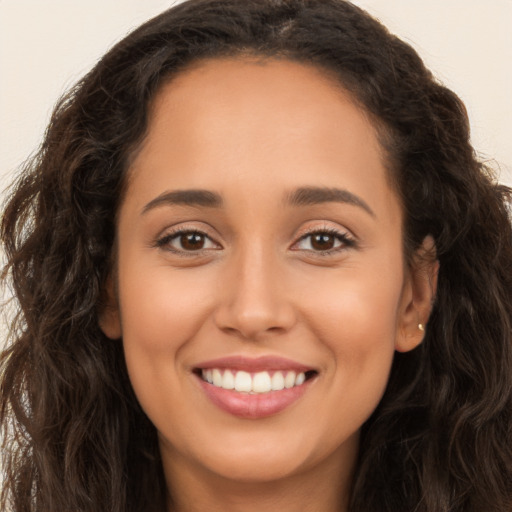 Joyful white young-adult female with long  brown hair and brown eyes