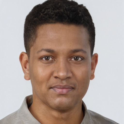 Joyful black young-adult male with short  brown hair and brown eyes