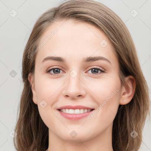 Joyful white young-adult female with long  brown hair and grey eyes