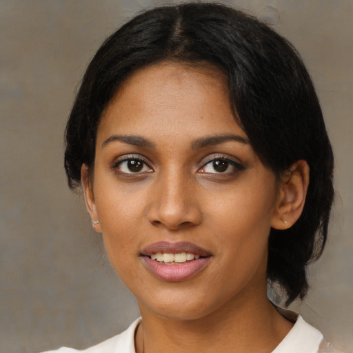 Joyful black young-adult female with medium  black hair and brown eyes