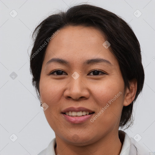 Joyful asian adult female with medium  brown hair and brown eyes