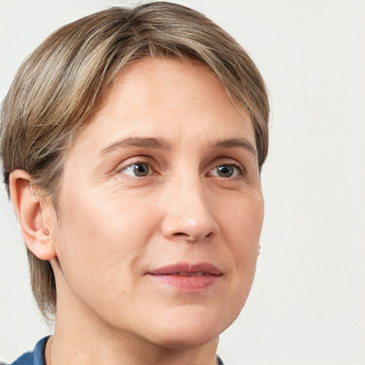 Joyful white adult female with short  brown hair and grey eyes