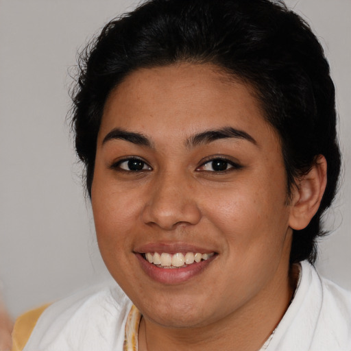 Joyful latino young-adult female with medium  brown hair and brown eyes