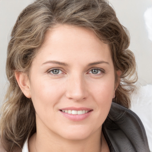 Joyful white young-adult female with medium  brown hair and blue eyes