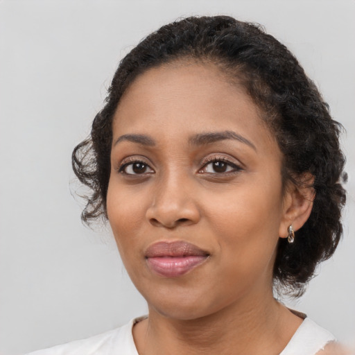 Joyful black young-adult female with medium  black hair and brown eyes