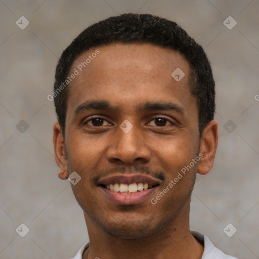 Joyful black young-adult male with short  black hair and brown eyes