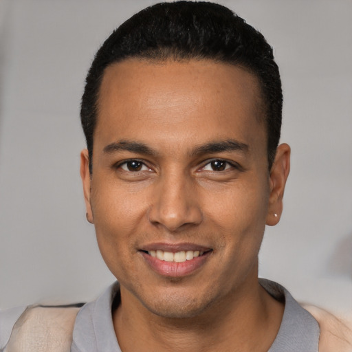 Joyful white young-adult male with short  black hair and brown eyes