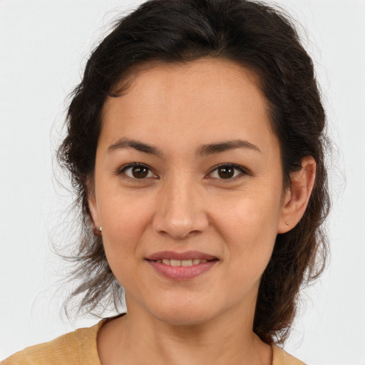 Joyful latino young-adult female with medium  brown hair and brown eyes