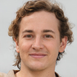 Joyful white young-adult male with medium  brown hair and brown eyes