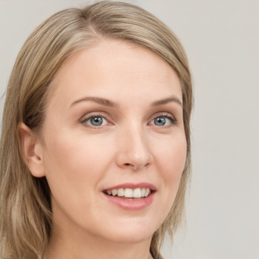 Joyful white young-adult female with long  brown hair and grey eyes