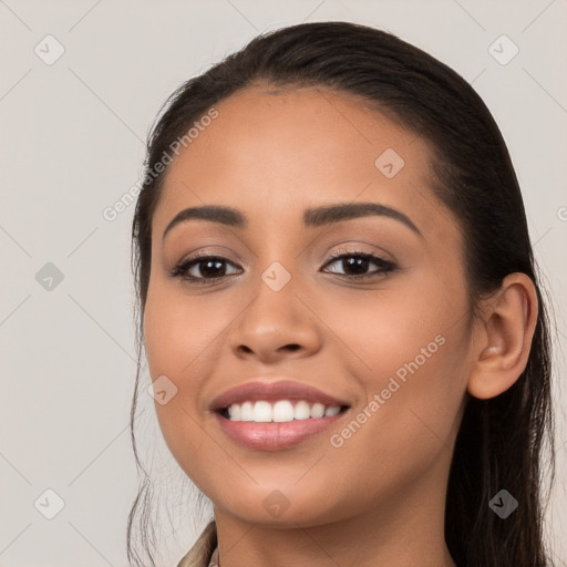 Joyful latino young-adult female with long  brown hair and brown eyes