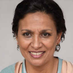 Joyful latino adult female with short  brown hair and brown eyes