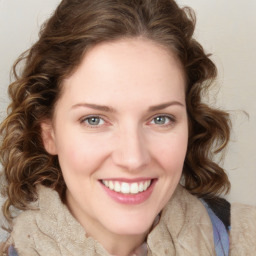 Joyful white young-adult female with medium  brown hair and blue eyes