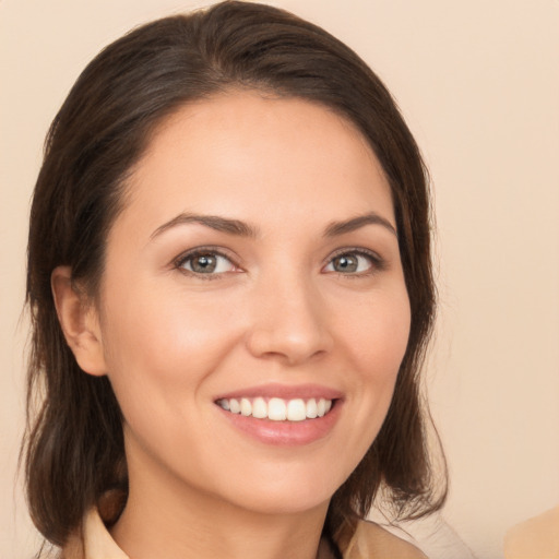 Joyful white young-adult female with medium  brown hair and brown eyes