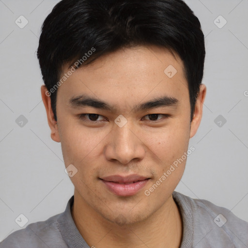 Joyful asian young-adult male with short  black hair and brown eyes