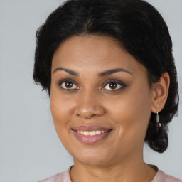 Joyful black young-adult female with medium  brown hair and brown eyes