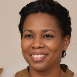 Joyful black adult female with short  brown hair and brown eyes